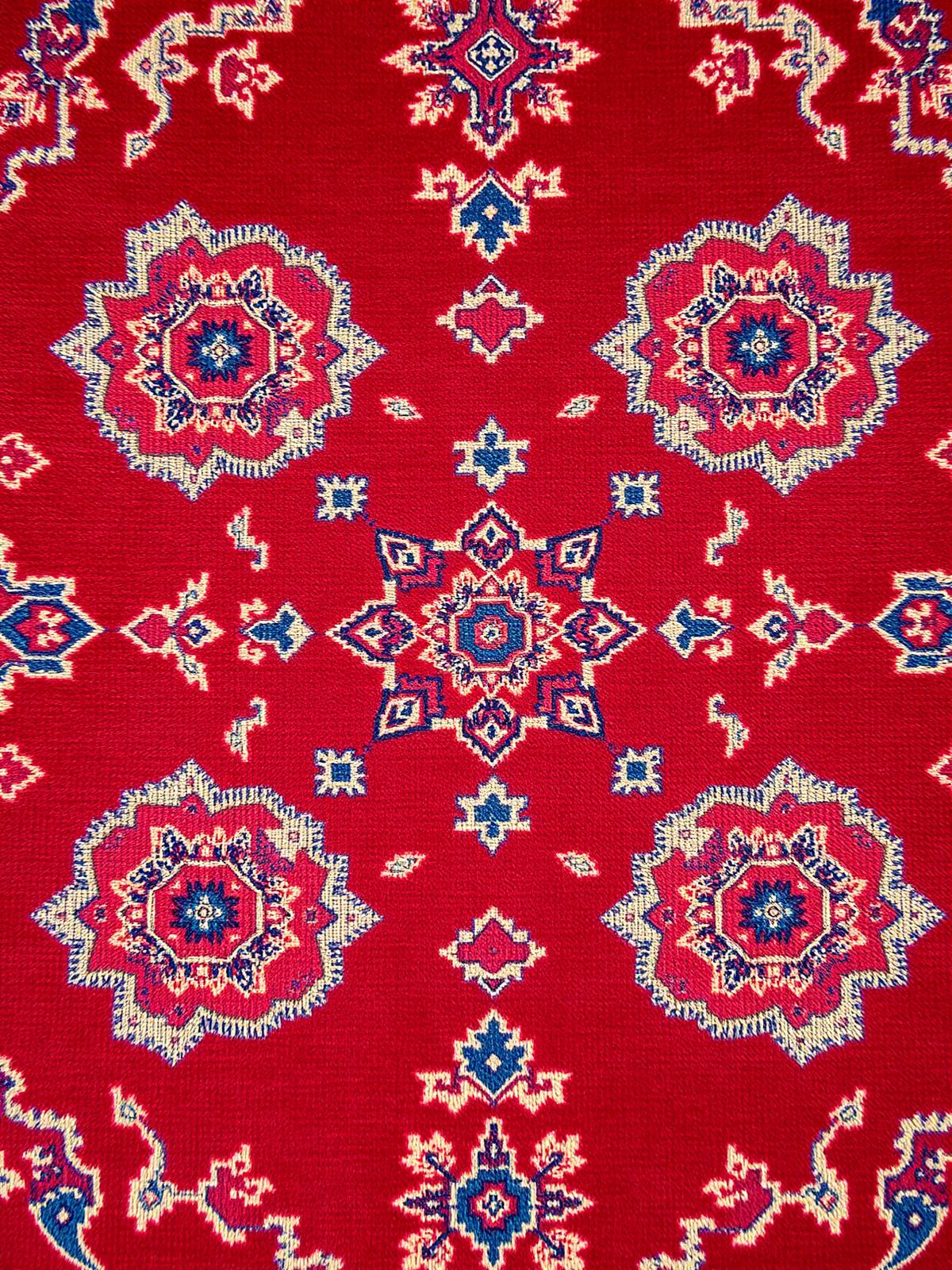 Close detail of a deep red Konya rug